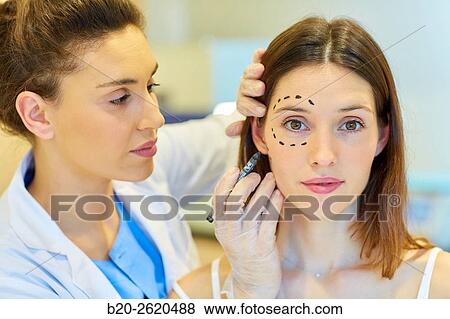 Facelift. Blepharoplasty. Surgery that aims to rejuvenate the look. It is to remove excess skin and bags of both eyelids and periocular tissue remodeling. Plastic surgery. Doctor attending to patient medical consultation. View Large Photo Image Stock Photo - Facelift. Blepharoplasty. Surgery that aims to rejuvenate the look. It is to remove excess skin and bags of both eyelids and periocular tissue remodeling. Plastic surgery. Doctor attending to patient medical consultation.. Fotosearch
