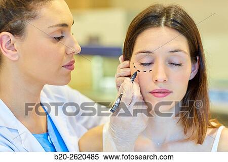 Facelift. Blepharoplasty. Surgery that aims to rejuvenate the look. It is to remove excess skin and bags of both eyelids and periocular tissue remodeling. Plastic surgery. Doctor attending to patient medical consultation. View Large Photo Image Stock Photography - Facelift. Blepharoplasty. Surgery that aims to rejuvenate the look. It is to remove excess skin and bags of both eyelids and periocular tissue remodeling. Plastic surgery. Doctor attending to patient medical consultation.. Fotosearch