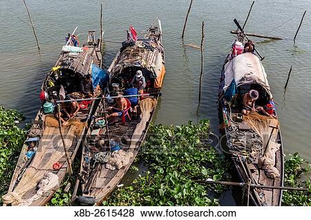 Families in their river boats at the local market in Chau Doc, Mekong River Delta, Vietnam. View Large Photo Image Stock Photo - Families in their river boats at the local market in Chau Doc, Mekong River Delta, Vietnam.. Fotosearch