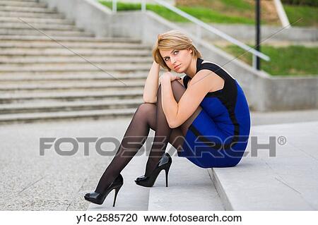 Fanciful attractive woman sitting on low staircase View Large Photo Image Stock Image - Fanciful attractive woman sitting on low staircase. Fotosearch