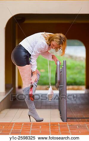 Fanciful young woman in Gray high-heeled boots bending-over View Large Photo Image Stock Photography - Fanciful young woman in Gray high-heeled boots bending-over. Fotosearch