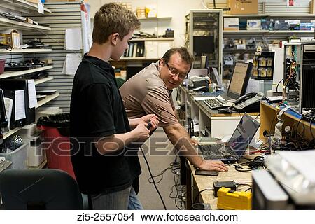 Father is training his son in computer repair shop View Large Photo Image Picture - Father is training his son in computer repair shop. Fotosearch