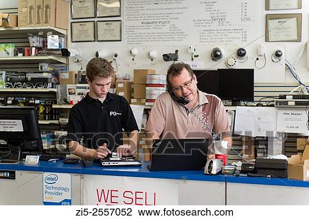 Father is training his son in computer repair shop View Large Photo Image Stock Image - Father is training his son in computer repair shop. Fotosearch
