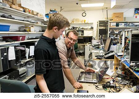 Father is training his son in computer repair shop View Large Photo Image Stock Photography - Father is training his son in computer repair shop. Fotosearch