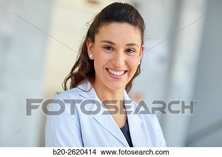 Picture - Female Doctor, looking at camera, Plastic Surgeon. Fotosearch