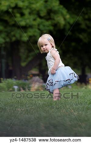 Female toddler enjoying a day at the park View Large Photo Image Stock Photo - Female toddler enjoying a day at the park. Fotosearch
