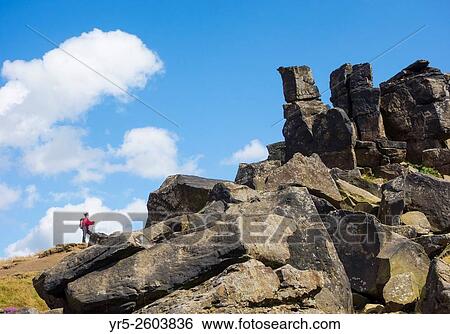Female walker on The Wainstones at Hasty Bank on The Cleveland Way National Trail. North York Moors National Park, England, United Kingdom. View Large Photo Image Stock Photograph - Female walker on The Wainstones at Hasty Bank on The Cleveland Way National Trail. North York Moors National Park, England, United Kingdom.. Fotosearch