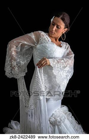 Stock Photo - Flamenco dancer backs with white dress on black background.. Fotosearch