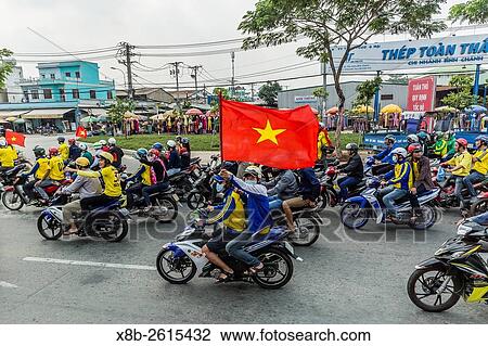 Football fans support their team on motor scooters in the city of Saigon, Ho Chi Minh City, Vietnam. View Large Photo Image Stock Image - Football fans support their team on motor scooters in the city of Saigon, Ho Chi Minh City, Vietnam.. Fotosearch