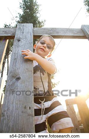 Four-year-old boy playing at the park in the evening. View Large Photo Image Picture - Four-year-old boy playing at the park in the evening.. Fotosearch