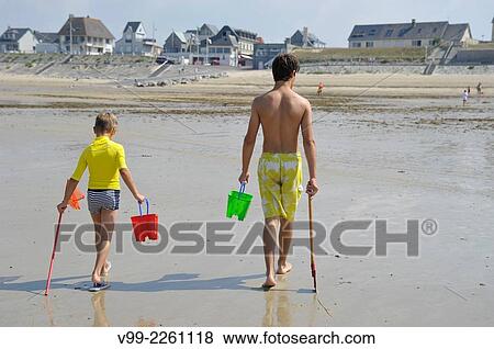 France, Normandy, Man and boy on beach View Large Photo Image Stock Photo - France, Normandy, Man and boy on beach. Fotosearch