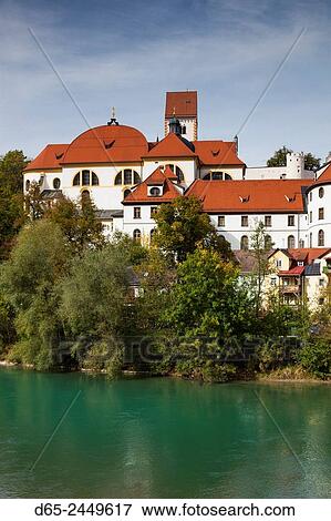 Germany, Bavaria, Fussen, St. Mang Abbey and the Hohes Scholoss Castle from the Lech River. View Large Photo Image Stock Photo - Germany, Bavaria, Fussen, St. Mang Abbey and the Hohes Scholoss Castle from the Lech River.. Fotosearch