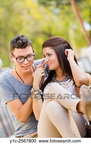 Girl and boy listen to cellphone talk together. View Large Photo Image Stock Image - Girl and boy listen to cellphone talk together.. Fotosearch