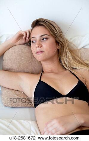 Stock Image - girl in bed with bikini. Fotosearch