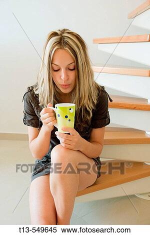 Girl is sitting on stairs and drinking coffee. View Large Photo Image Stock Photography - Girl is sitting on stairs and drinking coffee.. Fotosearch
