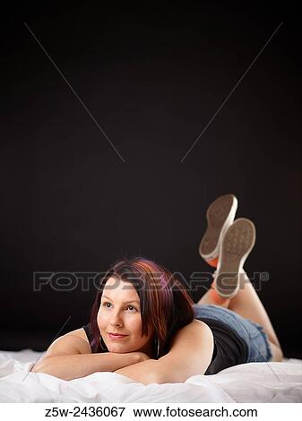 Girl on Bed in Converse Sneakers. View Large Photo Image Stock Photo - Girl on Bed in Converse Sneakers.. Fotosearch
