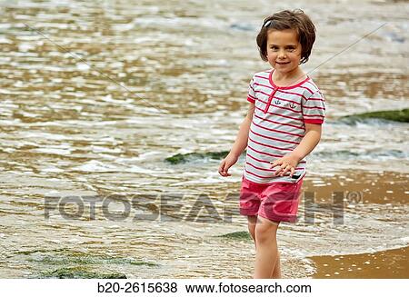 Girl playing on the beach. Getaria. Gipuzkoa. Basque Country. Spain View Large Photo Image Stock Photo - Girl playing on the beach. Getaria. Gipuzkoa. Basque Country. Spain. Fotosearch