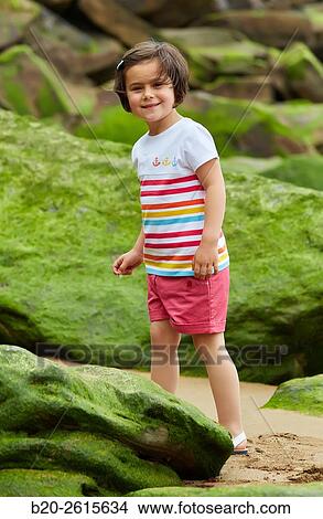Girl playing on the rocks. Getaria. Gipuzkoa. Basque Country. Spain View Large Photo Image Picture - Girl playing on the rocks. Getaria. Gipuzkoa. Basque Country. Spain. Fotosearch