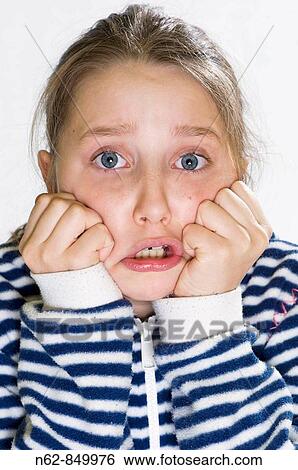Girls desperately held his face with his hands in fists closed View Large Photo Image Stock Photograph - Girls desperately held his face with his hands in fists closed. Fotosearch