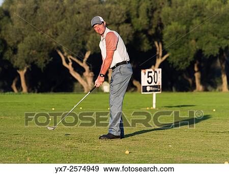 Golfer getting ready to swing. View Large Photo Image Stock Photo - Golfer getting ready to swing.. Fotosearch