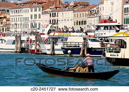Gondola and gondolier, Palaces facades, boats and vaporetto, Canal Grande, Venice, Venetia, Italy. View Large Photo Image Stock Photo - Gondola and gondolier, Palaces facades, boats and vaporetto, Canal Grande, Venice, Venetia, Italy.. Fotosearch