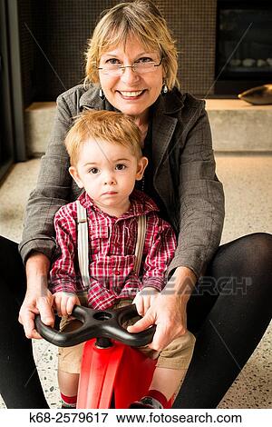 grandmother and grandson on a toy vehicle View Large Photo Image Stock Photo - grandmother and grandson on a toy vehicle. Fotosearch
