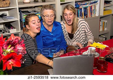 grandmother with two grandchildren having fun in front of laptop View Large Photo Image Stock Photo - grandmother with two grandchildren having fun in front of laptop. Fotosearch