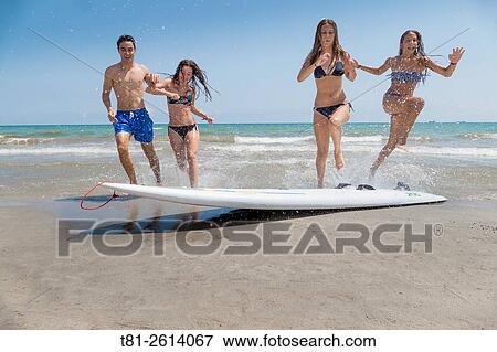 group of girls and boy running on the beach in Castellon. Espaa View Large Photo Image Stock Photo - group of girls and boy running on the beach in Castellon. Espaa. Fotosearch