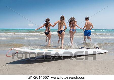 group of girls and boy running on the beach in Castellon. Spain View Large Photo Image Stock Photo - group of girls and boy running on the beach in Castellon. Spain. Fotosearch