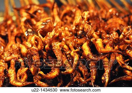 Stock Image - Guangzhou (China): octopus skewers sold in the Changshoulu neighborhood. Fotosearch