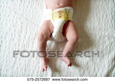 Half body of a newborn baby with a diaper on a changing table View Large Photo Image Stock Photo - Half body of a newborn baby with a diaper on a changing table. Fotosearch