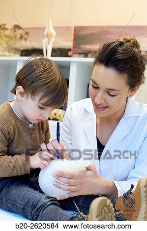 Picture - Hand child. Congenital hand. Doctor attending to patient medical consultation. Office. Plastic surgery. Pediatrician.. Fotosearch