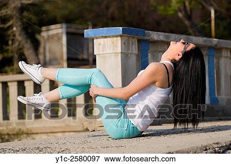 Happy and balancing on her bottom young woman View Large Photo Image Stock Photo - Happy and balancing on her bottom young woman. Fotosearch