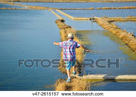 Happy boy jumping ditches rice fields, Albufera in Valencia, Spain, Europe View Large Photo Image Stock Photo - Happy boy jumping ditches rice fields, Albufera in Valencia, Spain, Europe. Fotosearch