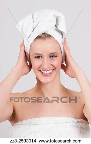 Happy woman after shower with a white towel on her head. View Large Photo Image Picture - Happy woman after shower with a white towel on her head.. Fotosearch