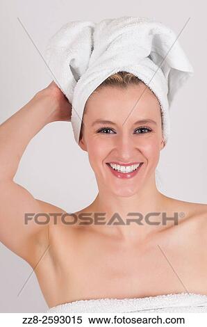 Stock Photography - Happy woman after shower with a white towel on her head.. Fotosearch