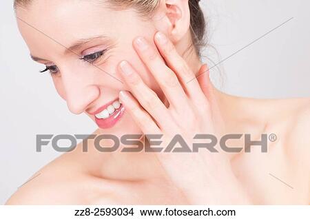 Happy young woman hand touching face. View Large Photo Image Picture - Happy young woman hand touching face.. Fotosearch