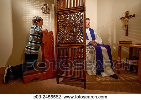 Hidden by a screen, a priest hears confession from a kneeling boy parishioner at a Laguna Niguel, CA, Catholic church. Note vestments. MODEL RELEASE. View Large Photo Image Stock Image - Hidden by a screen, a priest hears confession from a kneeling boy parishioner at a Laguna Niguel, CA, Catholic church. Note vestments. MODEL RELEASE.. Fotosearch