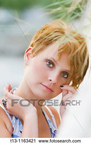 Holding a patch of hair young woman close-up View Large Photo Image Stock Image - Holding a patch of hair young woman close-up. Fotosearch