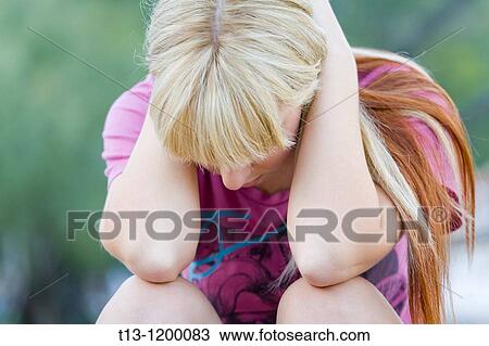 Holding her head between hands depressed young woman View Large Photo Image Stock Image - Holding her head between hands depressed young woman. Fotosearch