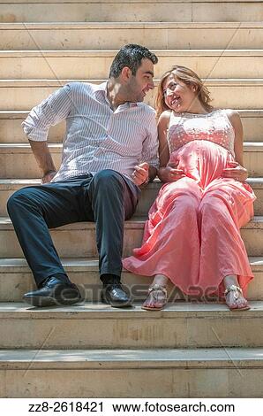 Stock Image - Husband with pregnant wife outdoors.. Fotosearch