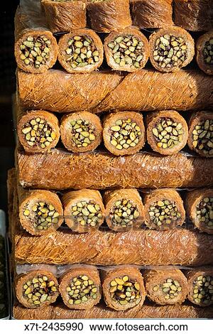 Kadayif, rolls of honey soaked, shredded pastry stuffed with nuts. A traditional Turkish dessert for sale in a shop window in Sultanahmet, Istanbul. View Large Photo Image Stock Image - Kadayif, rolls of honey soaked, shredded pastry stuffed with nuts. A traditional Turkish dessert for sale in a shop window in Sultanahmet, Istanbul.. Fotosearch