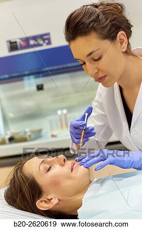 Stock Photo - Lipofilling. Fat Grafting. Liposculpture. Lipofilling is based on patients own fat transfer to another area, either for body shaping and facial rejuvenation. The fat is removed by liposuction of the donor site, usually lower abdomen or thighs. Subsequentl. Fotosearch