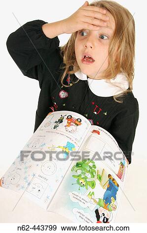 Little girl in elementary schools with unease puts her hand on her forehead while the other hand holds a workbook View Large Photo Image Stock Photo - Little girl in elementary schools with unease puts her hand on her forehead while the other hand holds a workbook. Fotosearch