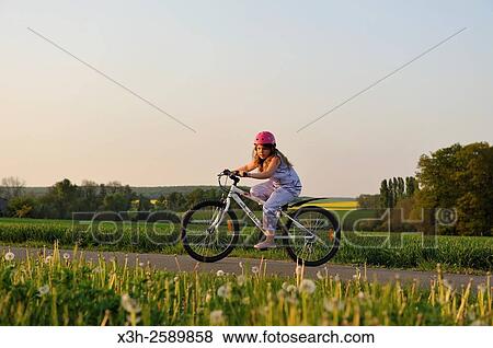 little girl on a mountain bike in the countryside, France, Europe View Large Photo Image Stock Photo - little girl on a mountain bike in the countryside, France, Europe. Fotosearch