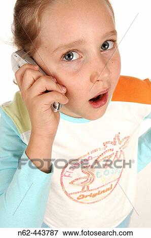 Stock Photo - Little girl top view answering her cell yawning. Fotosearch
