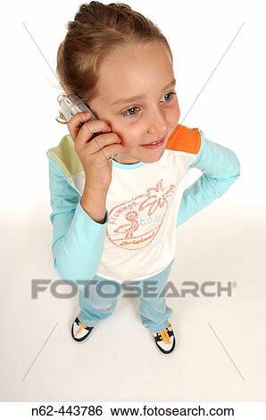 Little girl top view answers the cell phone smiling View Large Photo Image Stock Photograph - Little girl top view answers the cell phone smiling. Fotosearch