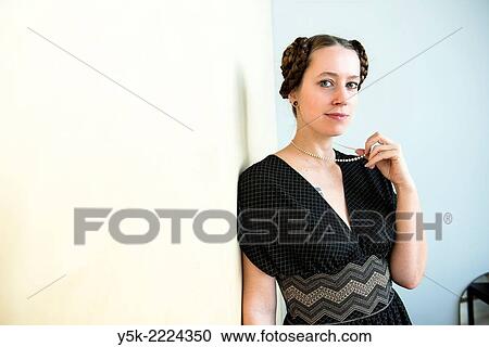Living room or salon of studio apartment, Eindhoven, Netherlands. Young, attractive woman with tresses and tails in her hear, wearing a pearl neckless inherited from her grandmother. View Large Photo Image Stock Image - Living room or salon of studio apartment, Eindhoven, Netherlands. Young, attractive woman with tresses and tails in her hear, wearing a pearl neckless inherited from her grandmother.. Fotosearch