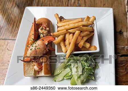 Lobster Roll, French Fries and Cucumber Salad, beautifully aranged on a white square plate. View Large Photo Image Stock Image - Lobster Roll, French Fries and Cucumber Salad, beautifully aranged on a white square plate.. Fotosearch