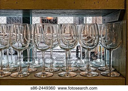 Stock Image - Long Stem Wine Glasses, Displayed in Rows on a Window Shelf, in a New York City Tableware Store.. Fotosearch